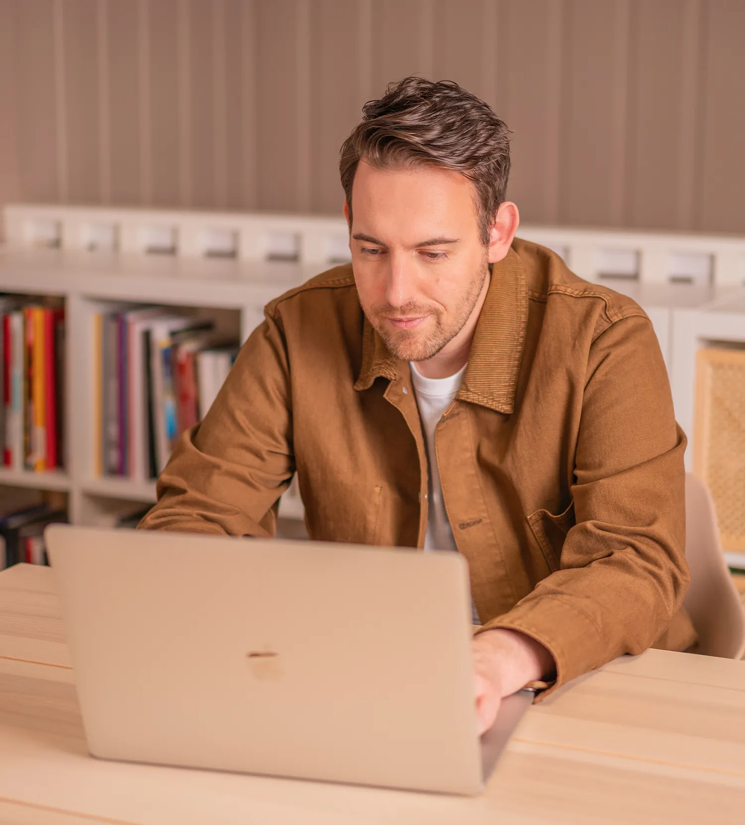 Bence Székely, content strategy consultant, reviewing a project  on a laptop